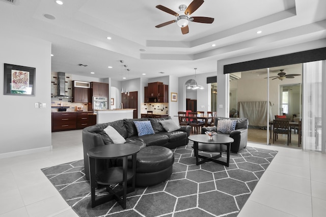 8881 Livingston Way, Boynton Beach, FL 33472 - living area featuring a ceiling fan, recessed lighting, light tile patterned flooring, and a raised ceiling