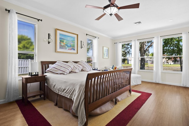 8881 Livingston Way, Boynton Beach, FL 33472 - bedroom with a ceiling fan, baseboards, wood finished floors, visible vents, and ornamental molding