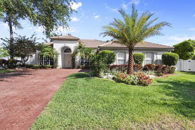 8881 Livingston Way, Boynton Beach, FL 33472 - mediterranean / spanish-style home featuring a front lawn, stucco siding, and a tile roof