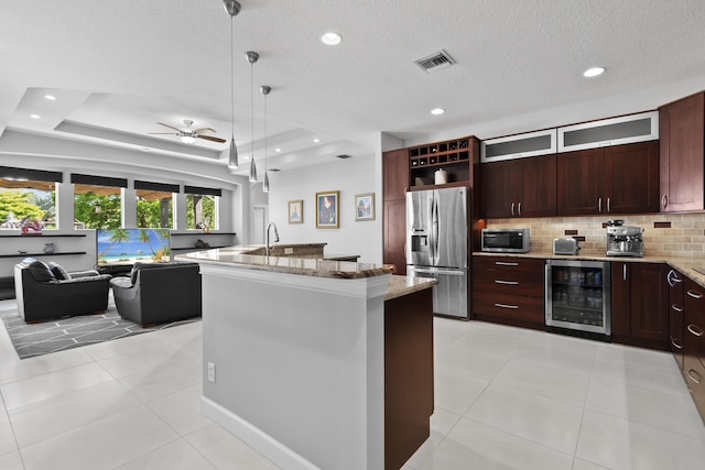 8881 Livingston Way, Boynton Beach, FL 33472 - kitchen with light stone countertops, beverage cooler, stainless steel appliances, open floor plan, and visible vents