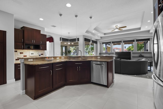 8881 Livingston Way, Boynton Beach, FL 33472 - kitchen with open floor plan, ceiling fan, a sink, appliances with stainless steel finishes, and backsplash
