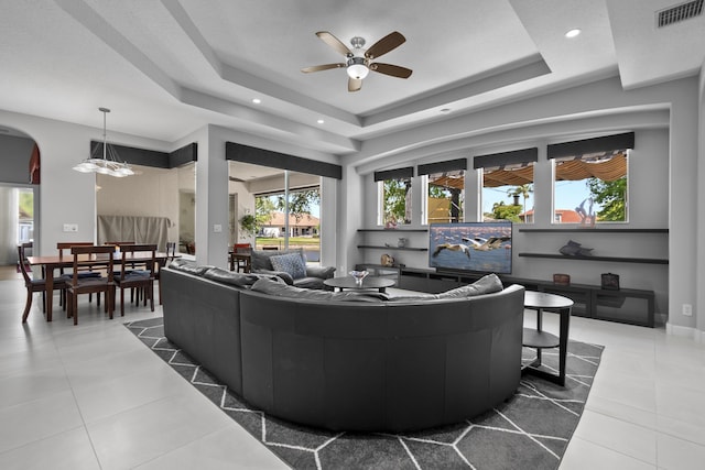 8881 Livingston Way, Boynton Beach, FL 33472 - tiled living area with arched walkways, a ceiling fan, recessed lighting, a tray ceiling, and visible vents