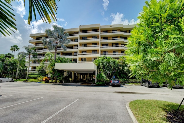 view of building exterior with uncovered parking