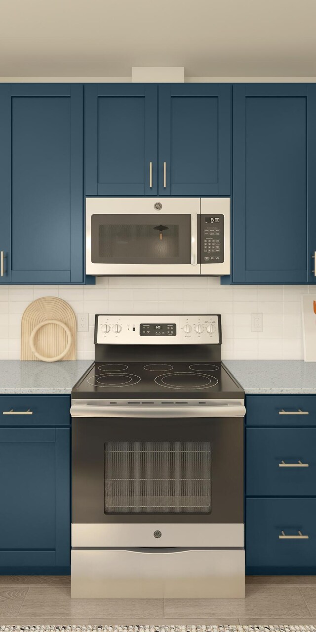 317 Silver Sands Ln Unit 10, Fort Pierce, FL 34945 - kitchen featuring light stone countertops, backsplash, stainless steel appliances, and blue cabinetry