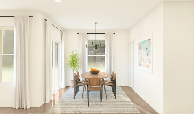 317 Silver Sands Ln Unit 10, Fort Pierce, FL 34945 - dining area with wood finished floors, a chandelier, and baseboards