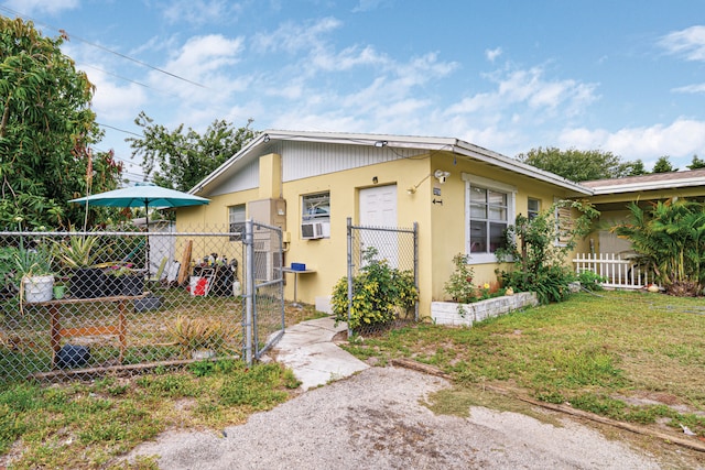 3208 Prince Dr, Lake Worth, FL 33461 - view of property exterior featuring a yard, fence, and a gate
