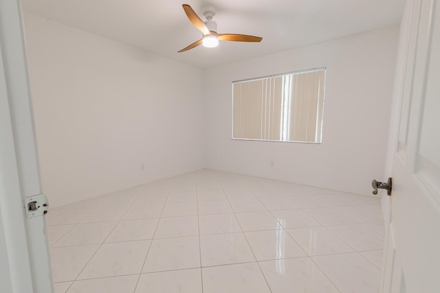 unfurnished room with light tile patterned floors and a ceiling fan