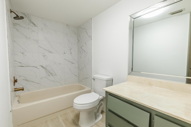 bathroom featuring vanity, shower / bathing tub combination, toilet, visible vents, and wood finished floors