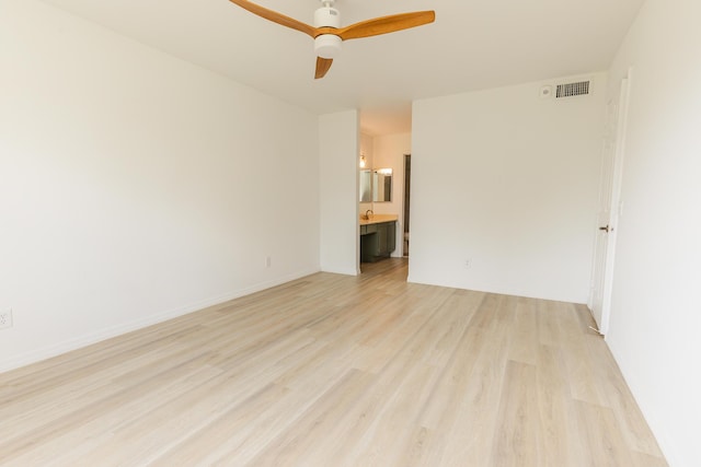 empty room with visible vents, ceiling fan, and light wood-style flooring