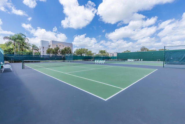 view of tennis court with fence and community basketball court