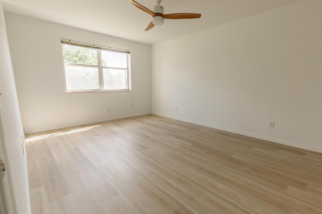unfurnished room with baseboards, light wood-type flooring, and ceiling fan