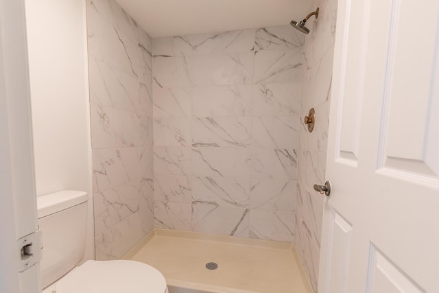 full bath featuring toilet and a stall shower