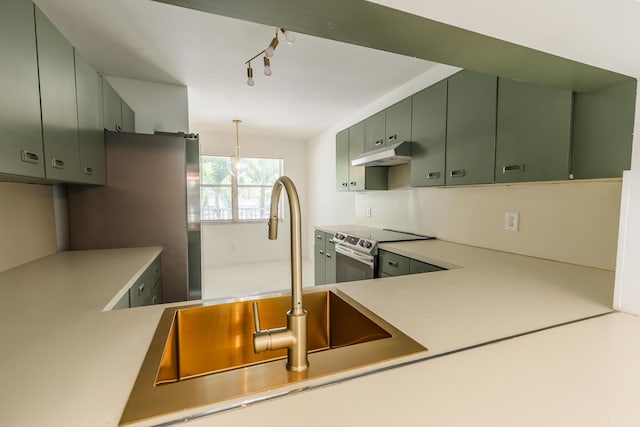 kitchen featuring a sink, appliances with stainless steel finishes, green cabinets, light countertops, and under cabinet range hood