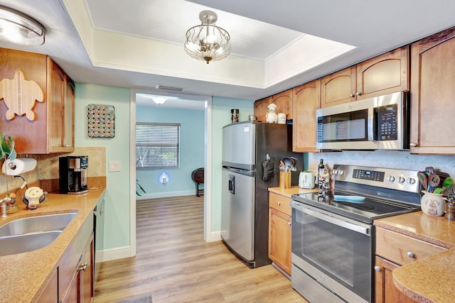 387 Yvonne Dr, West Palm Beach, FL 33406 - kitchen with stainless steel appliances, a raised ceiling, a sink, and decorative backsplash