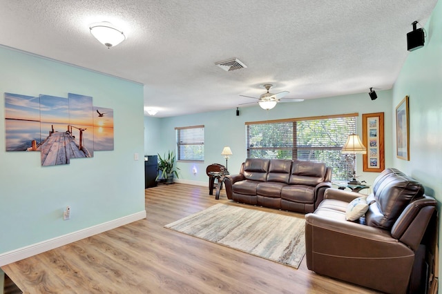 387 Yvonne Dr, West Palm Beach, FL 33406 - living room with a textured ceiling, wood finished floors, a ceiling fan, and baseboards