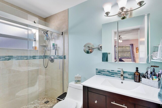 387 Yvonne Dr, West Palm Beach, FL 33406 - bathroom featuring a stall shower, toilet, a chandelier, vanity, and tasteful backsplash