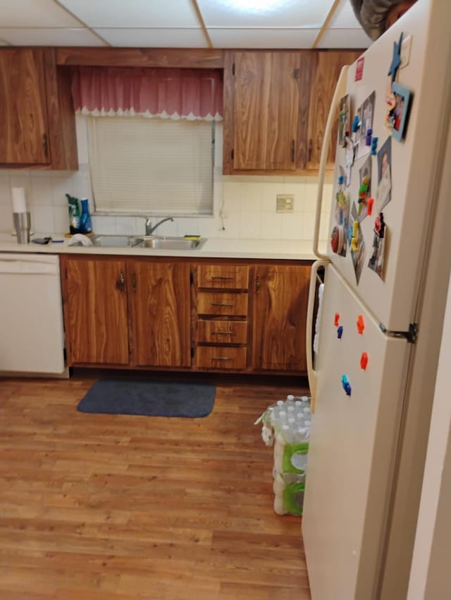 131 Lakes End Dr Unit D, Fort Pierce, FL 34982 - kitchen featuring white appliances, brown cabinetry, light countertops, and tasteful backsplash
