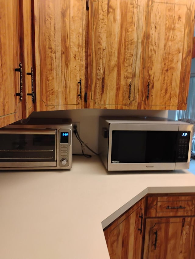 131 Lakes End Dr Unit D, Fort Pierce, FL 34982 - kitchen view of wood walls, light countertops, and brown cabinets