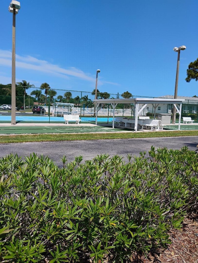131 Lakes End Dr Unit D, Fort Pierce, FL 34982 - exterior space with a tennis court and fence