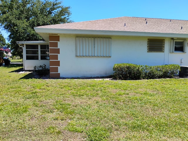 131 Lakes End Dr Unit D, Fort Pierce, FL 34982 - view of side of property featuring a lawn, a sunroom, stucco siding, and central AC unit