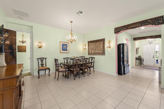 dining room featuring light tile patterned flooring, an inviting chandelier, baseboards, and visible vents