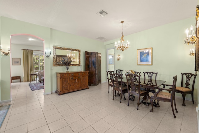 dining space with light tile patterned flooring, visible vents, and a notable chandelier