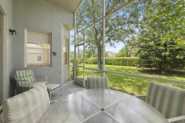 sunroom featuring outdoor dining space and plenty of natural light