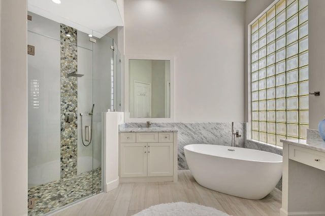 112 Dalena Way, Palm Beach Gardens, FL 33418 - full bathroom with vanity, a stall shower, a soaking tub, and tile walls