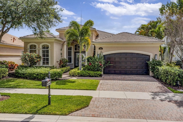 112 Dalena Way, Palm Beach Gardens, FL 33418 - mediterranean / spanish-style home with stucco siding, decorative driveway, a tiled roof, and a garage