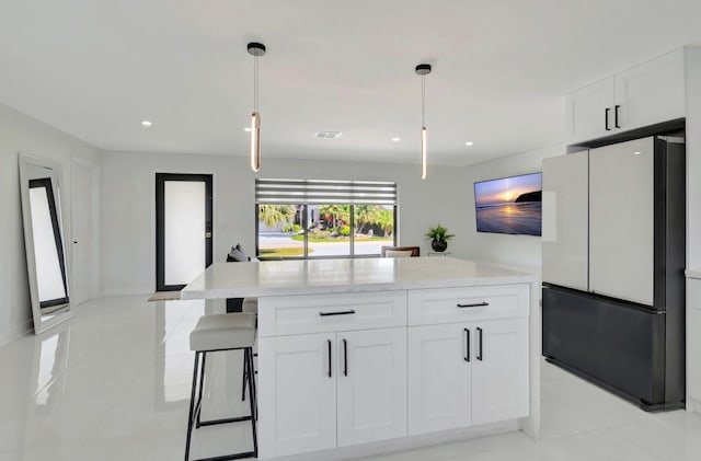 918 Turner Rd, Delray Beach, FL 33483 - kitchen with light countertops, freestanding refrigerator, light tile patterned flooring, and white cabinetry