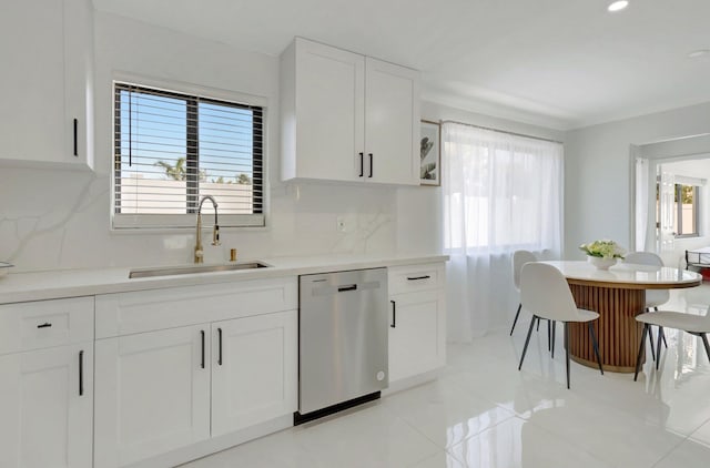 918 Turner Rd, Delray Beach, FL 33483 - kitchen featuring a sink, tasteful backsplash, stainless steel dishwasher, and white cabinetry