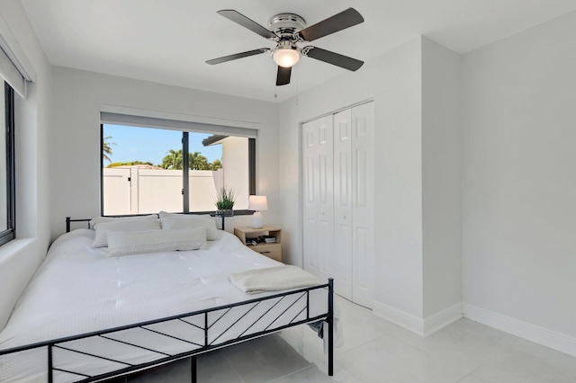 918 Turner Rd, Delray Beach, FL 33483 - bedroom featuring light tile patterned floors, baseboards, a ceiling fan, and a closet