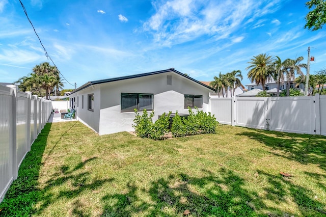918 Turner Rd, Delray Beach, FL 33483 - rear view of property with a fenced backyard, stucco siding, and a lawn