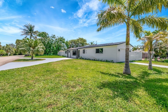 918 Turner Rd, Delray Beach, FL 33483 - view of front of home featuring concrete driveway, stucco siding, fence, and a front lawn