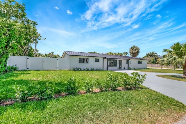 918 Turner Rd, Delray Beach, FL 33483 - ranch-style house with fence, metal roof, a gate, and a front lawn