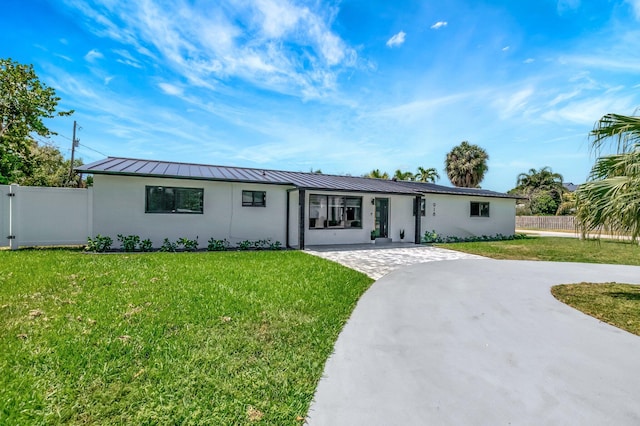 918 Turner Rd, Delray Beach, FL 33483 - ranch-style house with fence, a standing seam roof, metal roof, and a front yard