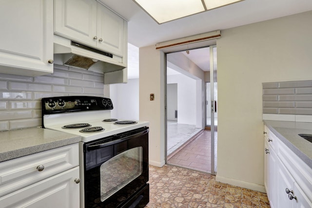 kitchen with under cabinet range hood, white cabinets, range with electric stovetop, and tasteful backsplash