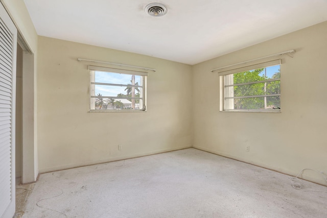 unfurnished bedroom with carpet floors, baseboards, visible vents, and a closet