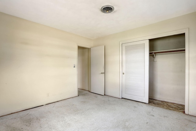 unfurnished bedroom featuring visible vents and a closet