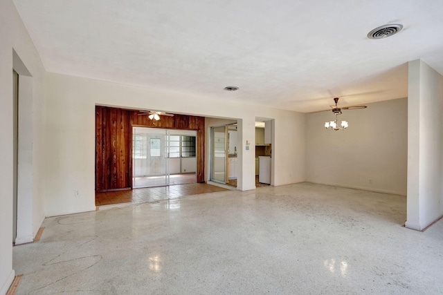 unfurnished room with baseboards, speckled floor, and visible vents