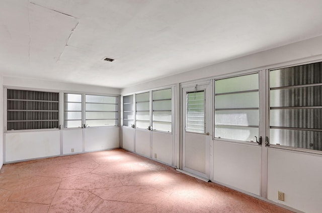 unfurnished sunroom featuring visible vents