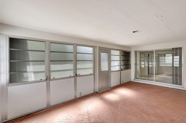 unfurnished sunroom with visible vents