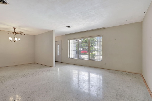 unfurnished room featuring visible vents, baseboards, ceiling fan, and speckled floor