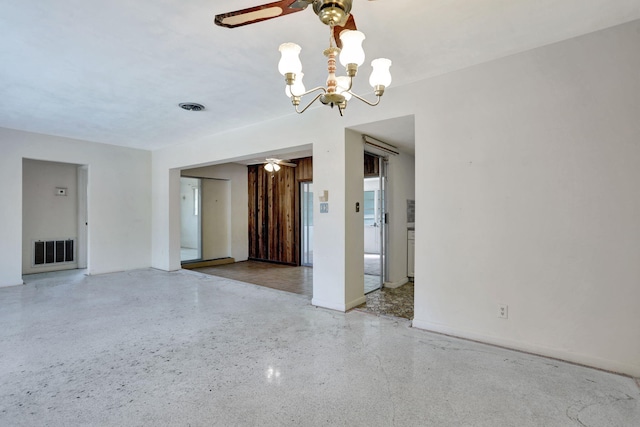 interior space with visible vents, ceiling fan with notable chandelier, and speckled floor