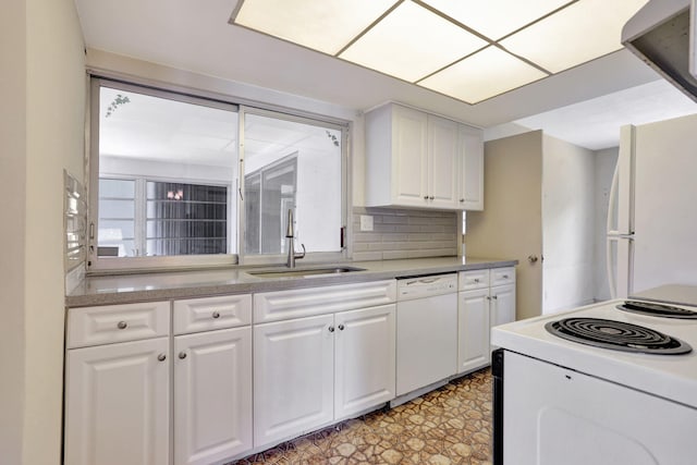 kitchen with a sink, white cabinets, white appliances, and light countertops