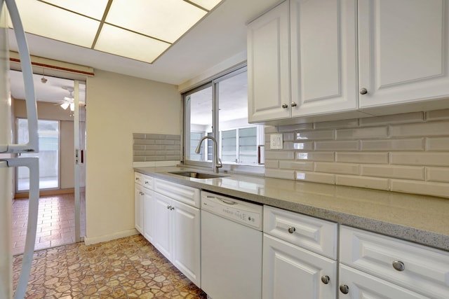 kitchen featuring a ceiling fan, backsplash, dishwasher, a sink, and white cabinets