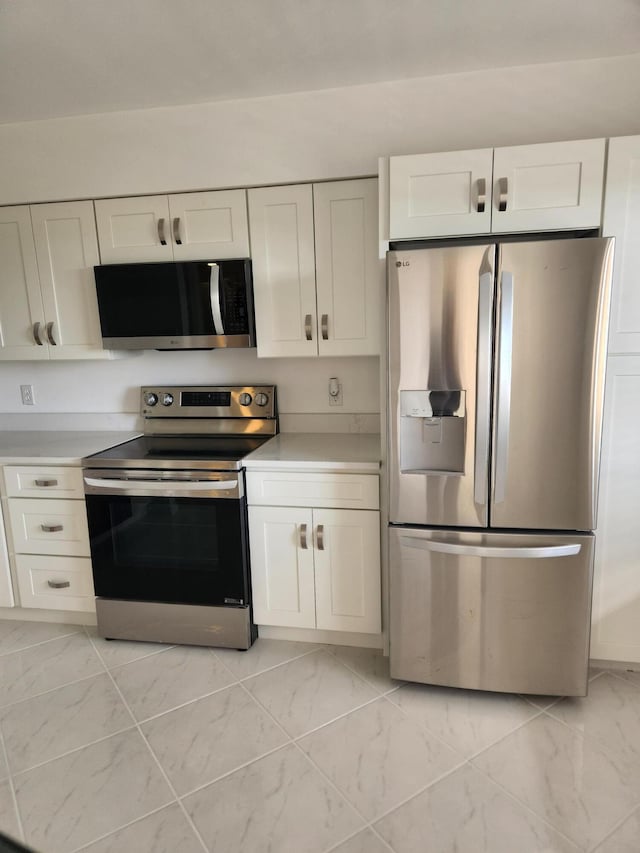 14475 N Strathmore Ln Unit 707, Delray Beach, FL 33446 - kitchen with stainless steel appliances, white cabinetry, and light countertops