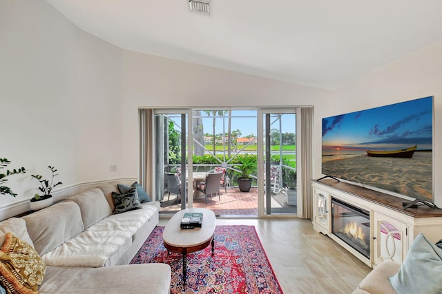 17352 Antigua Point Way, Boca Raton, FL 33487 - living room with a glass covered fireplace, visible vents, and lofted ceiling