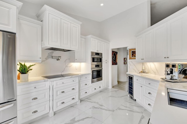17352 Antigua Point Way, Boca Raton, FL 33487 - kitchen with light countertops, white cabinetry, wine cooler, and stainless steel appliances
