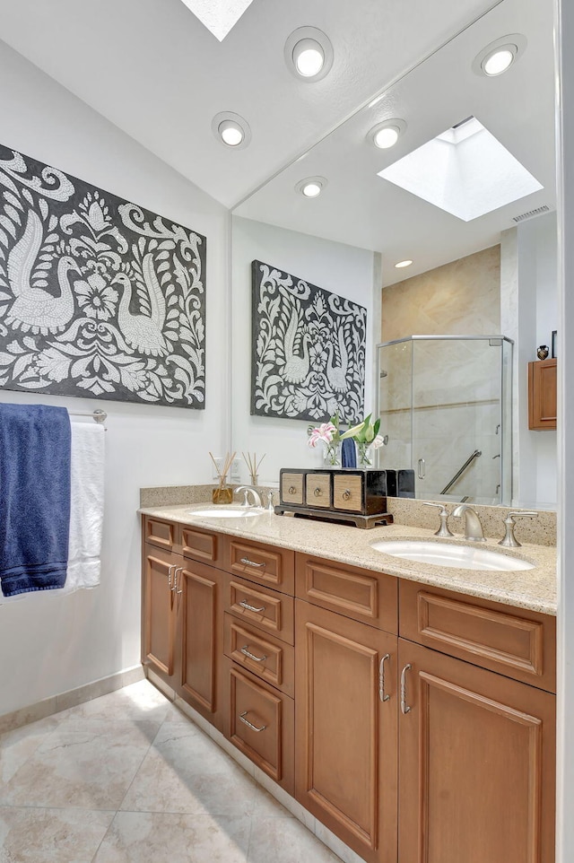 17352 Antigua Point Way, Boca Raton, FL 33487 - full bathroom featuring a sink, double vanity, baseboards, a skylight, and a stall shower
